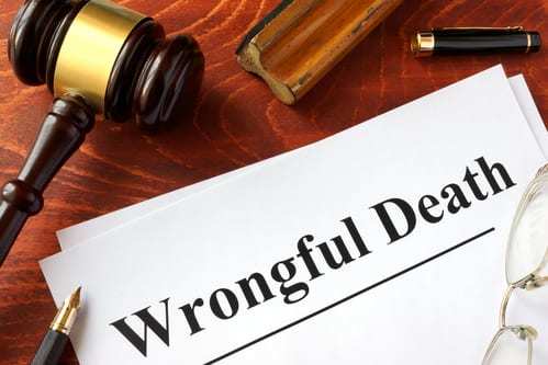 wrongful death printed on paper near gavel