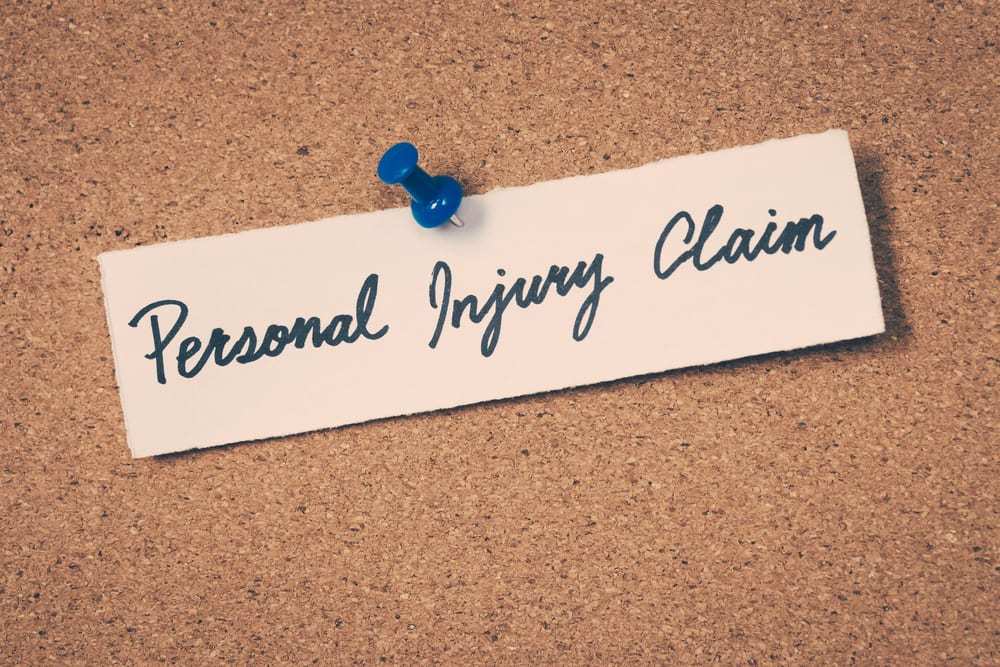 Personal injury claim written on paper, pinned to bulletin board