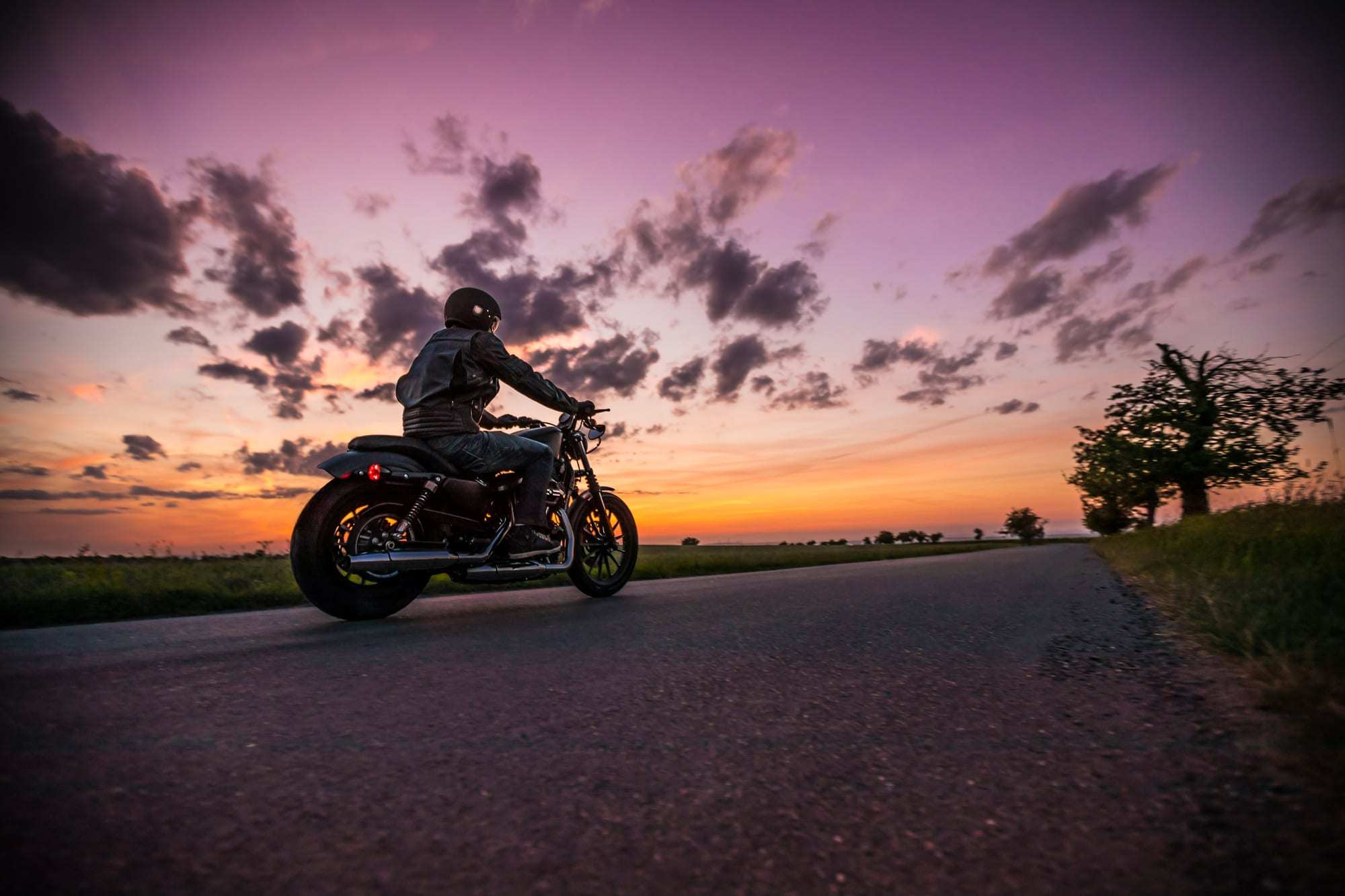 Man Riding Motorcycle During Beautiful Sunset