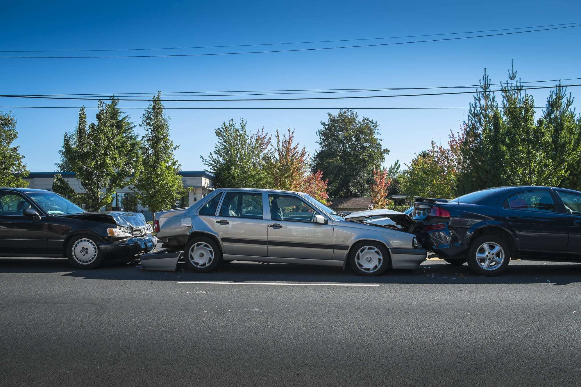 Three cars involved in an accident on a city street